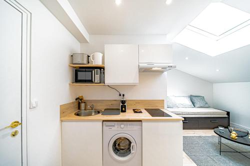 a kitchen with a washer and dryer in a room at Le Palo Alto - Joli studio rénové in Oullins