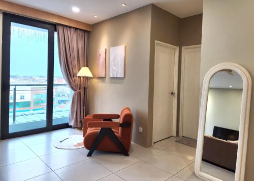 a living room with a chair and a mirror at Kuching Prime Location Emporium - Nordict Retrett - 10 Pax in Kuching