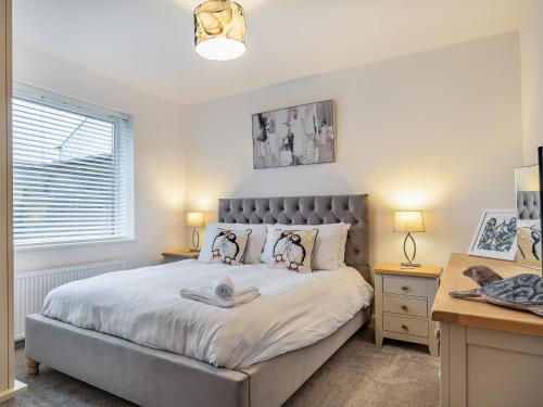 a bedroom with a large bed and a desk at Broadacre House in Brixham