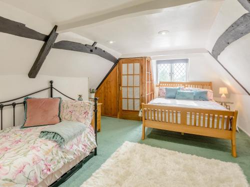 a bedroom with a bed and a couch and a window at Yew Tree Farm in Charing