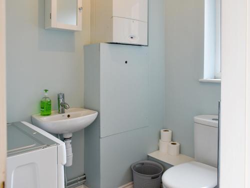 a white bathroom with a sink and a toilet at Archers Retreat in Greenhill