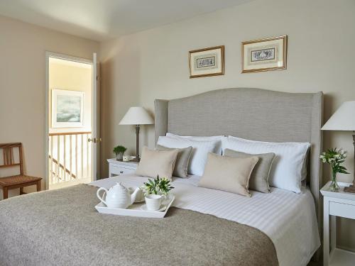 a bedroom with a large bed with a tray on it at Levisham in Pickering