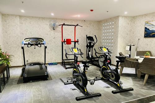 a gym with several treadmills and exercise bikes at Lanura Apartments and Hotel in Ho Chi Minh City