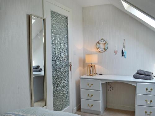 a bedroom with a dressing table and a mirror at Ingleside in Ballantrae