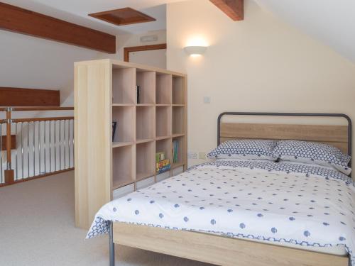 a bedroom with a bed and a book shelf at Marina Retreat in Milford Haven