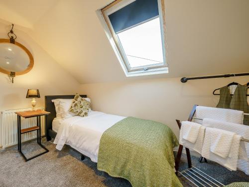 a bedroom with a bed and a window and a chair at Valley View in Malvern Wells