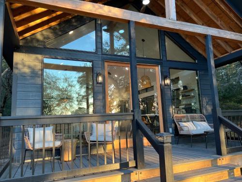 a screened in porch of a house with glass doors at Relaxing Modern stay on a Ranch in Cedar Creek