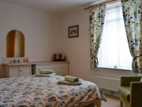 a bedroom with a bed and a window at Mountain View in Silloth