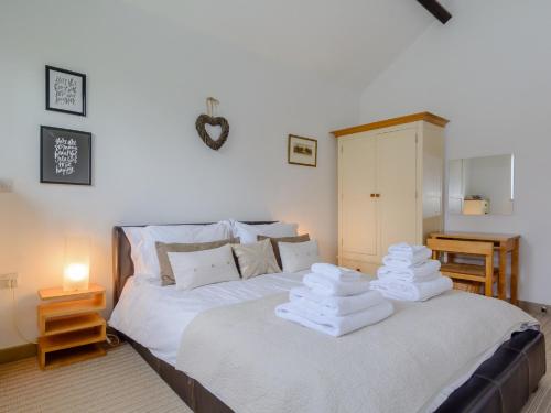 a bedroom with a bed with towels on it at Primrose in Shepton Mallet