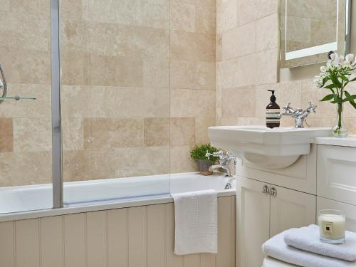 a bathroom with a tub and a sink and a shower at Farndale in Pickering