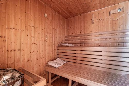 a wooden sauna with a wooden bench in it at Pool Villa Adonis - Happy Rentals in Semič