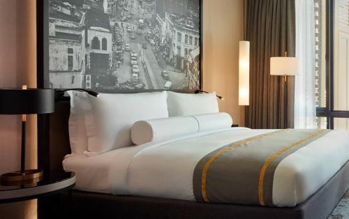 a large white bed in a hotel room at Hotel Stripes Kuala Lumpur, Autograph Collection in Kuala Lumpur