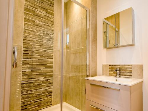 a bathroom with a shower and a sink at The Manor Coach House in Chilham