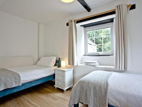 two beds in a room with a window at Stables - Uk31176 in Saint Martin