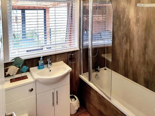 a bathroom with a sink and a shower at Ratagan Lodge in Kintail