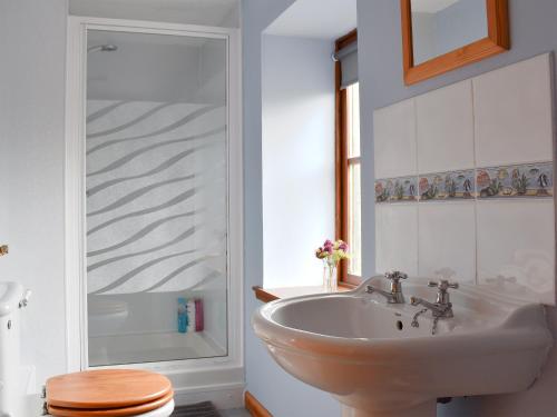 a bathroom with a sink and a shower at The Cottage At Cauldcoats in Linlithgow