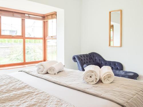 a bedroom with a bed with towels on it at Summer Hill in Kilgetty