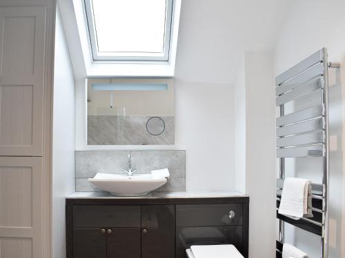 a bathroom with a sink and a skylight at The Old Chapel in Ashover