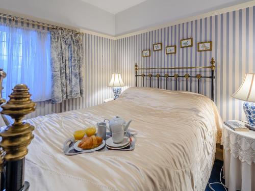 a bedroom with a bed with a tray of food on it at Brandon in Sutton on Sea