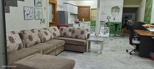 a living room with a couch and a table at Ipoh Family Homestay - Maximum 10 family members in Ipoh