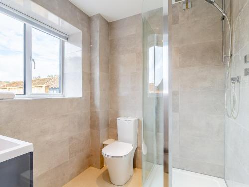 a bathroom with a toilet and a shower at Kestrel Barn-uk31353 in Swaffham