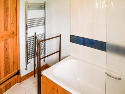 a bathroom with a bath tub and a shower at The Long Barn in Little Baddow