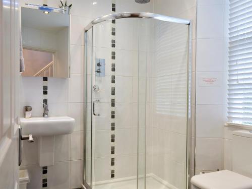 a bathroom with a shower and a sink and a toilet at Ellerview House in Ambleside