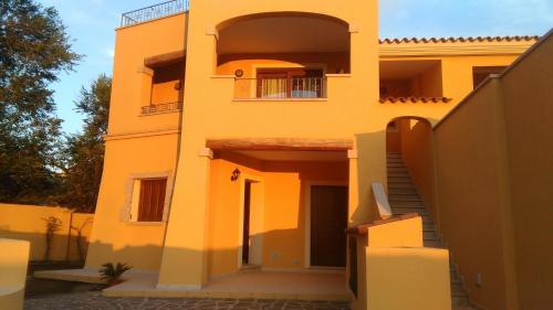a orange building with a staircase and a balcony at Casa Marina Maria in Murta Maria