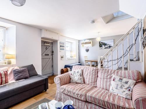 a living room with a couch and a staircase at Sunny Shores - Uk32245 in Aberdyfi