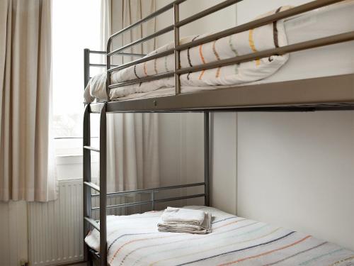 a bedroom with two bunk beds in a room at Drift In in Yapton
