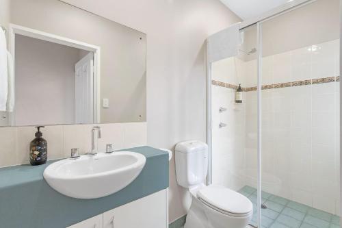 a bathroom with a sink and a toilet and a shower at Jervis Bay Vista in Huskisson