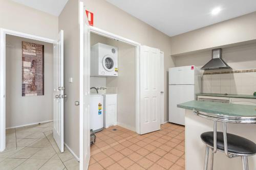 a kitchen with a white refrigerator and a counter at Jervis Bay Vista in Huskisson