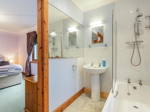 a bathroom with a shower and a sink and a tub at Bidean Lodge in Glencoe