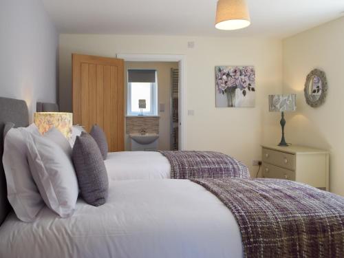 a bedroom with two beds and a bathroom at The Retreat - Uk33306 in Hayscastle