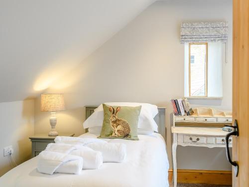 a bedroom with a bed with towels on it at The Granary in Hough on the Hill