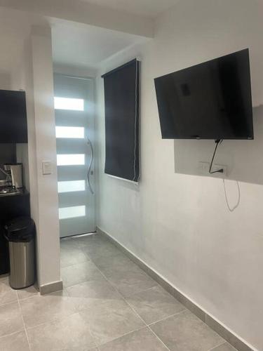a room with a flat screen tv on a wall at Perfect suite #6 in San Juan