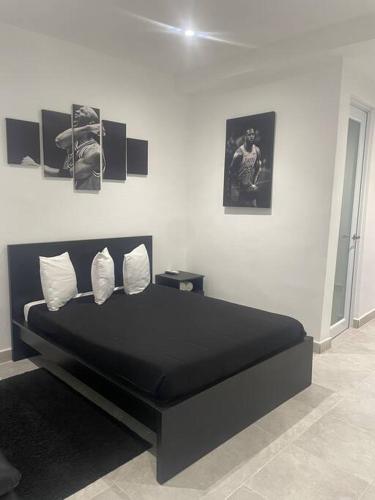 a bedroom with a large black bed in a room at Perfect suite #6 in San Juan