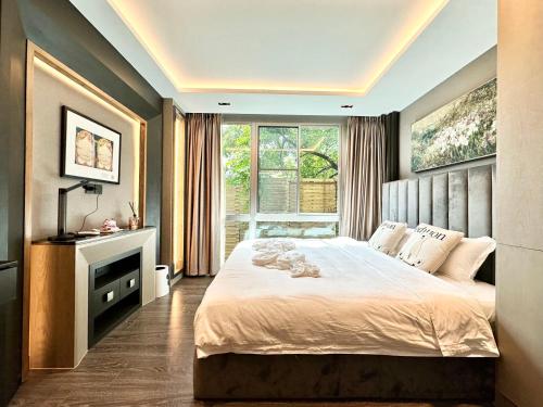 a bedroom with a large bed and a window at Erawan condo in Chiang Mai