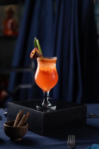 a drink in a glass sitting on a table at Bayon Modern Residence in Siem Reap