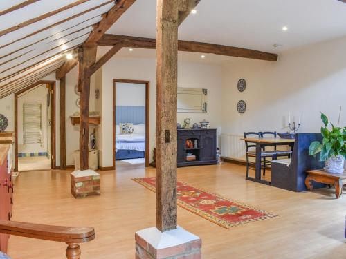 a living room with wooden beams and a dining room at The Parlour in Hadlow Down