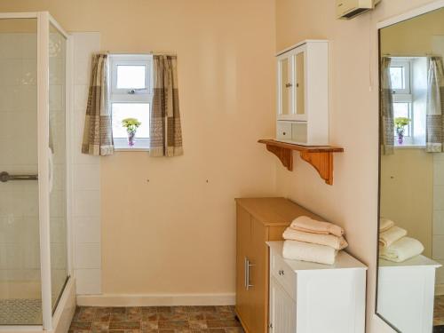 a bathroom with a shower and a sink at Sea Scape in Bacton