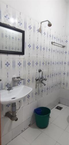 a white bathroom with a sink and a window at Noor Plaza in Angamali