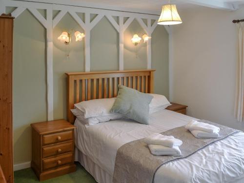 a bedroom with a bed with two towels on it at The Haven in Crantock