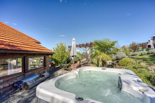 a hot tub in the backyard of a house at Romantic Haven with Hot Tub - Happy Rentals in Beretinec
