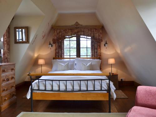 a bedroom with a bed in a attic at Bakers Cottage in Hotham