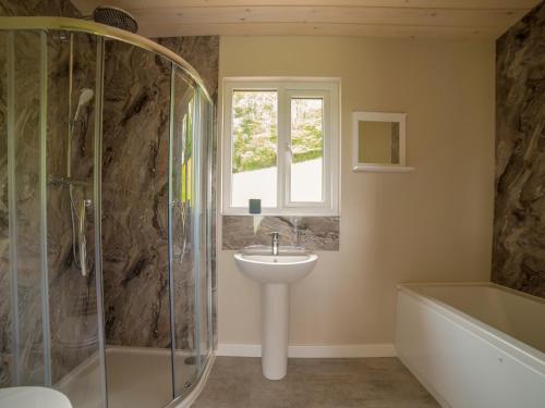 a bathroom with a sink and a shower and a tub at Barn Owl Lodge-qu7487 in Highgate