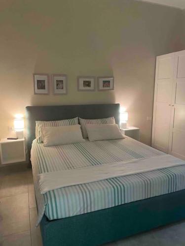 a bedroom with a large bed with two pillows at La magia del mare in Sardegna (I.U.N. Q5901) in Iglesias