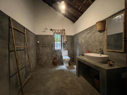 a bathroom with a sink and a toilet at Anestwella in Tangalle