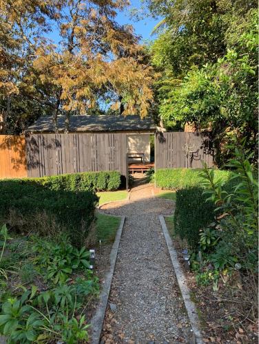 a garden with a fence and a wooden gate at Charming Country Retreat in Hamilton