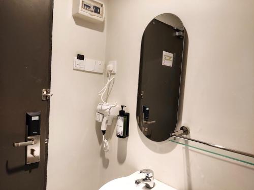 a bathroom with a mirror and a sink at The Leverage Business Hotel - Bandar Baru Mergong in Alor Setar